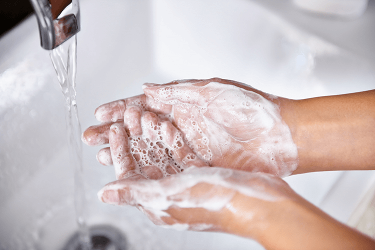 A person washing their hands to prevent pinworm infection and reinfection