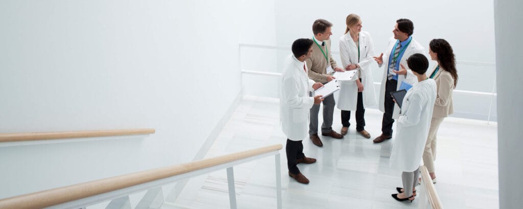 a group of doctors discussing something in white lab coats